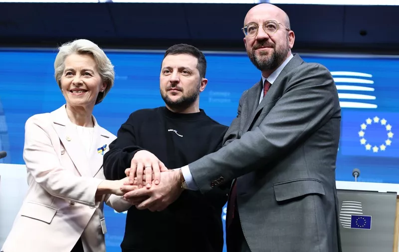 President of the European Council Charles Michel (R) European Commission President Ursula von der Leyen and Ukrainian president Volodymyr Zelensky shake hands following a press conference after a round-table meeting as part of a EU summit in Brussels, on February 9, 2023. Ukraine's President is set to attend an EU summit in Brussels on February 9, 2023, as the guest of honour where he will press allies to deliver fighter jets "as soon as possible" in the war against Russia. (Photo by KENZO TRIBOUILLARD / AFP)