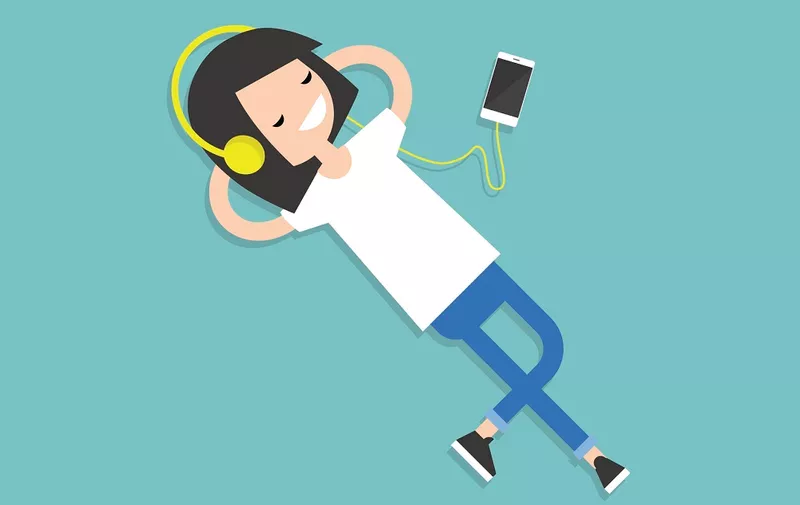 Happy young girl with headphones listening to music on a floor. Top view / flat editable vector illustration