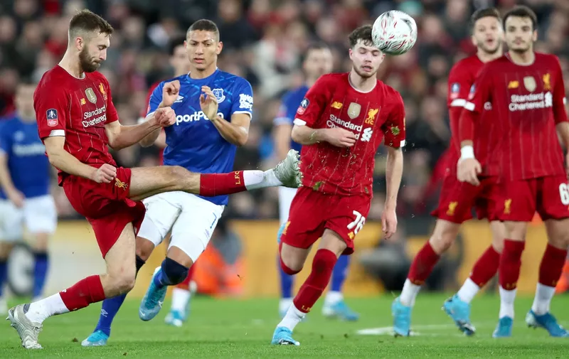 LIVERPOOL, ENGLAND - JANUARY 05: Nathaniel Phillips of Liverpool clears the ball under pressure from Richarlison of Everton during the FA Cup Third Round match between Liverpool and Everton at Anfield on January 05, 2020 in Liverpool, England. (Photo by Clive Brunskill/Getty Images)