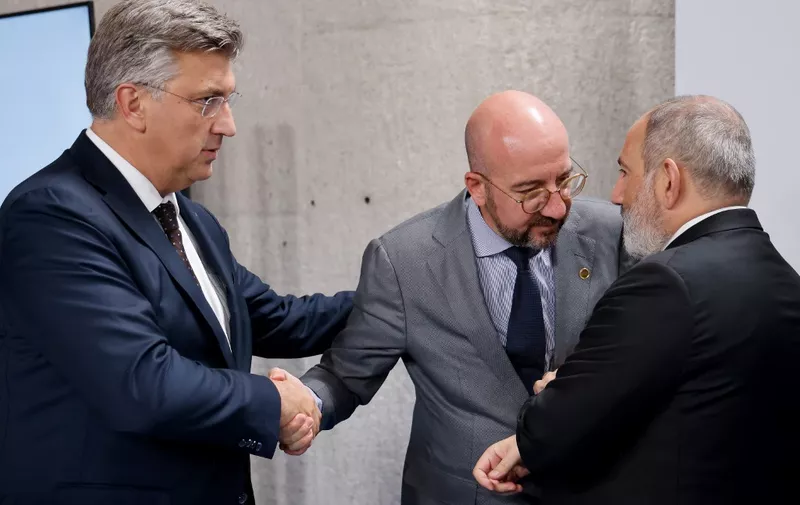 (From L) Croatia's Prime Minister Andrej Plenkovic greets European Council President Charles Michel and Armenian Prime Minister Nikol Pashinyan at the start of a plenary session of the European Political Community summit at the Palacio de Congreso in Granada, southern Spain on October 5, 2023. Europe's quest to build a common geopolitical purpose brought four dozen of its leaders to Granada, but its credibility suffered a blow when the Azerbaijani president stayed away. (Photo by Ludovic MARIN / AFP)