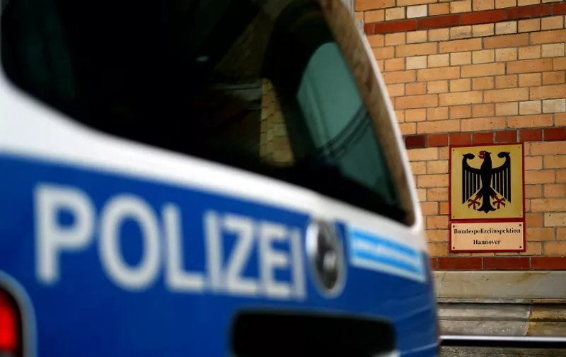A police car is seen in front of the entrance of the Federal police station at the central train station in Hanover, northern Germany on May 18, 2015, where a police officer allegedly abused two refugees, strangling an Afghan man in March 2014 and forcing a Moroccan man to eat rotten pork off the floor months later. Prosecutors announced on May 18, 2015 that they are investigating the officer, who has been suspended, on charges of physical assault and illegal weapons possession and have searched his home and work place.
AFP PHOTO / RONNY HARTMANN