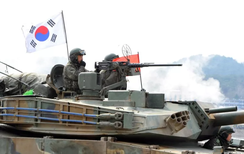 (FILES) This file photo taken on April 1, 2013 shows a South Korean K-1 tank moving over a temporary bridge during a river-crossing military drill in Hwacheon, near the border with North Korea. South Korea on August 20, 2015 fired dozens of shells across the border into North Korea in retaliation for an apparent North Korean rocket attack, Seoul's defence ministry said.    AFP PHOTO / FILES / KIM JAE-HWAN