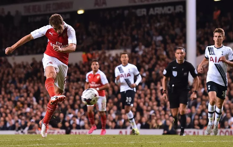 Arsenal's French midfielder Mathieu Flamini (L) shoots to score their seond goal during the English League Cup third round football match between Tottenham Hotspur and Arsenal at White Hart Lane in north London on September 23, 2015. AFP PHOTO / BEN STANSALL

RESTRICTED TO EDITORIAL USE. No use with unauthorized audio, video, data, fixture lists, club/league logos or 'live' services. Online in-match use limited to 75 images, no video emulation. No use in betting, games or single club/league/player publications.