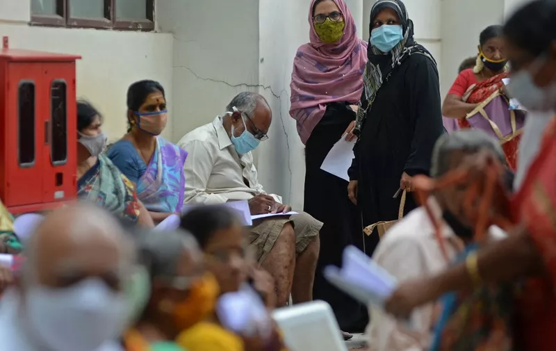 People wait for their turn to receive the Covid-19 coronavirus vaccine at a government hospital in Chennai on April 16, 2021. (Photo by Arun SANKAR / AFP)