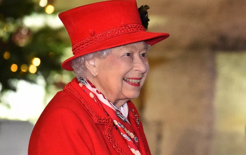 Britain's Queen Elizabeth II thanks local volunteers and key workers for the work they are doing during the coronavirus pandemic and over Christmas in the quadrangle of Windsor Castle in Windsor, west of London, on December 8, 2020 - The Queen and members of the royal family gave thanks to local volunteers and key workers for their work in helping others during the coronavirus pandemic and over Christmas at Windsor Castle in what was also the final stop for the Duke and Duchess of Cambridge on their tour of England, Wales and Scotland. (Photo by Glyn KIRK / various sources / AFP)