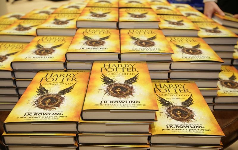 Piles of the new Harry Potter script book "Harry Potter and the Cursed Child Parts One &amp; Two" are pictured inside Waterstones bookshop on Piccadilly in central London early in the morning of July 31, 2016, during the midnight party celebrating the publication of "Harry Potter and the Cursed Child Parts One &amp; Two" script book. - Harry Potter fans were buzzing with excitement Saturday as "Harry Potter and the Cursed Child", a stage play that imagines the fictional boy wizard as a grown-up father of three, opened in London. The script will be released in Britain at midnight on Saturday (2300 GMT), with bookshops planning to stay open into the wee small hours to satisfy the desires of Potter fans. July 31 is the birthday of both Rowling and Potter. (Photo by Daniel LEAL / AFP)