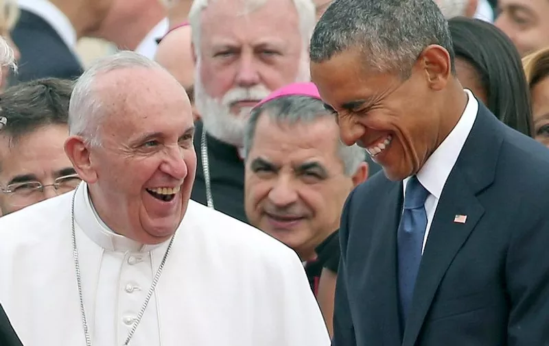 JOINT BASE ANDREWS, MD - SEPTEMBER 22: (EDITORS NOTE: Retransmission with alternate crop) Pope Francis (L) is escorted by U.S. President Barack Obama as he greets and other political and Catholic church leaders after arriving from Cuba September 22, 2015 at Joint Base Andrews, Maryland. Francis will be visiting Washington, New York City and Philadelphia during his first trip to the United States as Pope.   Chip Somodevilla/Getty Images/AFP