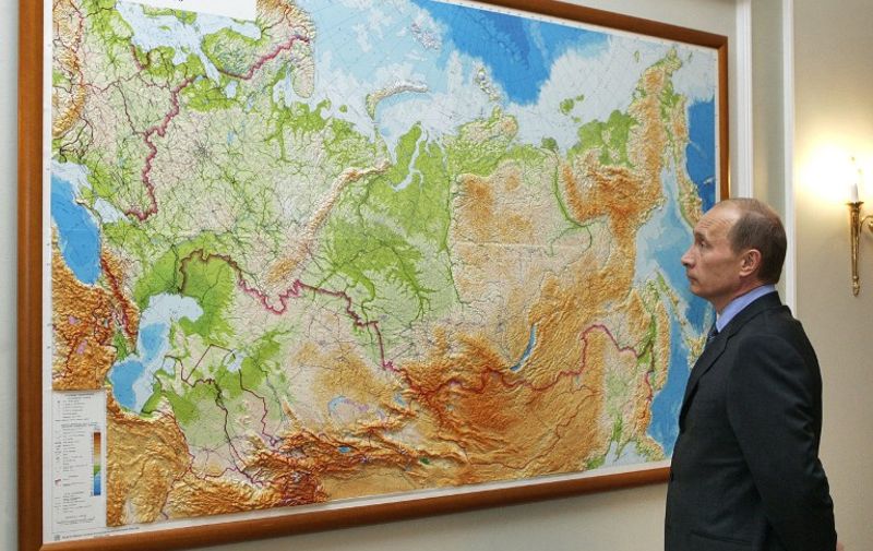 Russian President Vladimir Putin looks at a map in his country at his residence of Novo-Ogaryevo outside Moscow, 11 August 2006. Russian President Vladimir Putin and Iranian President Mahmud Ahmadinejad have discussed the situation in the Middle East in follow up to their telephone conversation in late July, the Kremlin press service reported on Friday. AFP PHOTO / ITAR-TASS POOL / PRESIDENTIAL PRESS SERVICE