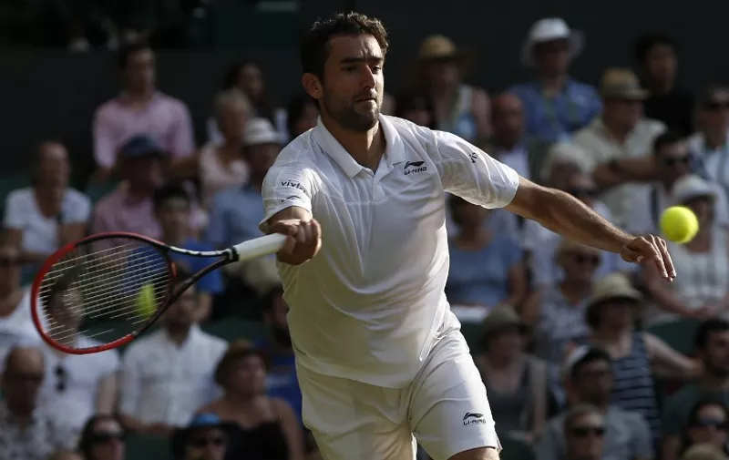Croatia's Marin Cilic returns against Lithuania's Ricardas Berankis during their men's singles second round match on day three of the 2015 Wimbledon Championships at The All England Tennis Club in Wimbledon, southwest London, on July 1, 2015.   RESTRICTED TO EDITORIAL USE  --   AFP PHOTO / ADRIAN DENNIS