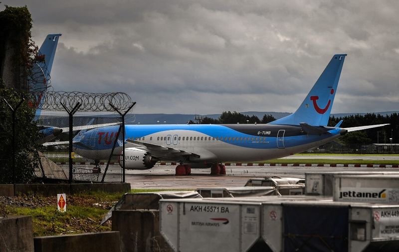 Aircraft operated by TUI are pictured at Manchester Airport in Manchester, north west England on July 27, 2020, following the holiday operator's decision to cancel all holidays to mainland Spain, due to a spike in the number of COVID-19 cases there. - Tour operator TUI has cancelled all British holidays to mainland Spain from Monday until August 9, after the UK government's decision to require travellers returning from the country to quarantine. The newly-imposed rule to self-isolate, abruptly introduced at midnight Saturday hours after being announced, follows a surge in novel coronavirus cases in parts of Spain in recent weeks. (Photo by Anthony Devlin / AFP)
