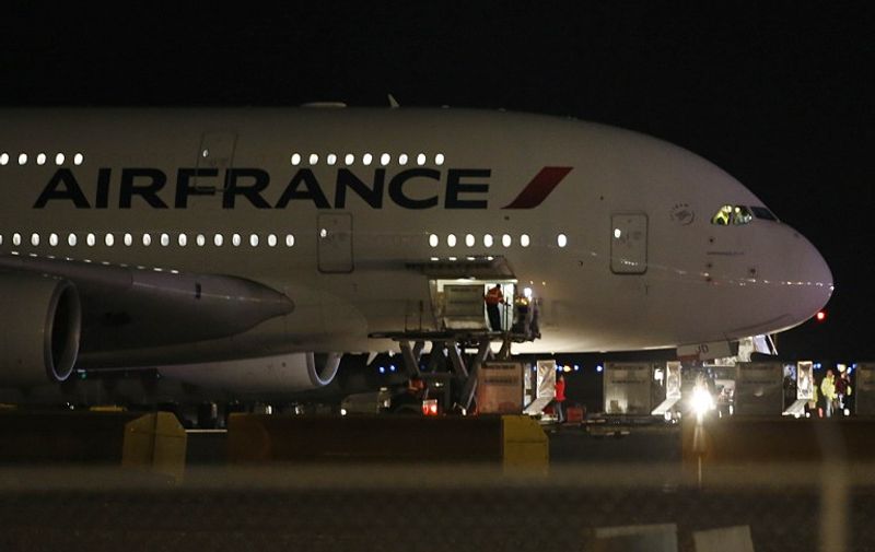 Air France Airbus 380, Flight 65,  sits on the runway at the Salt Lake City International Airport being inspected by the FBI on November 17, 2015 in Salt LAke City, Utah. Two Air France flights bound for Paris from the United States were diverted November 17, 2015 and landed safely after the airline received anonymous bomb threats, the carrier said.  Flight 65 from Los Angeles and Flight 55 from Washington were "subject to anonymous threats received after their respective takeoff," the airline said in a statement.   AFP PHOTO / GEORGE FREY / AFP / GEORGE FREY
