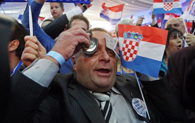 Suporters of the conservative opposition Croatian Democratic Union party celebrate after preleminary results of the general elections in Zagreb, on November 8, 2015.Croatia's conservative opposition bloc took the lead over the ruling centre-left alliance in today's election, according to preliminary results based on a partial vote count. AFP PHOTO / STRINGER