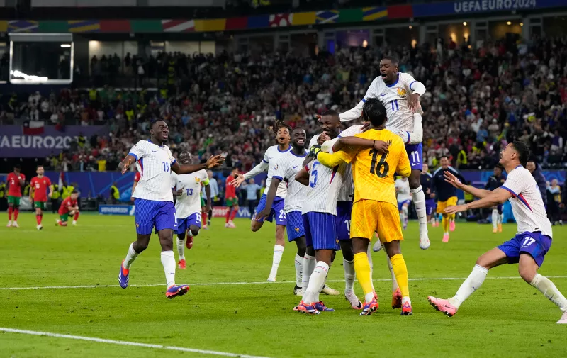 France players celebrate after penalty shootout against Portugal during a quarter final match at the Euro 2024 soccer tournament in Hamburg, Germany, Friday, July 5, 2024. (AP Photo/Hassan Ammar)