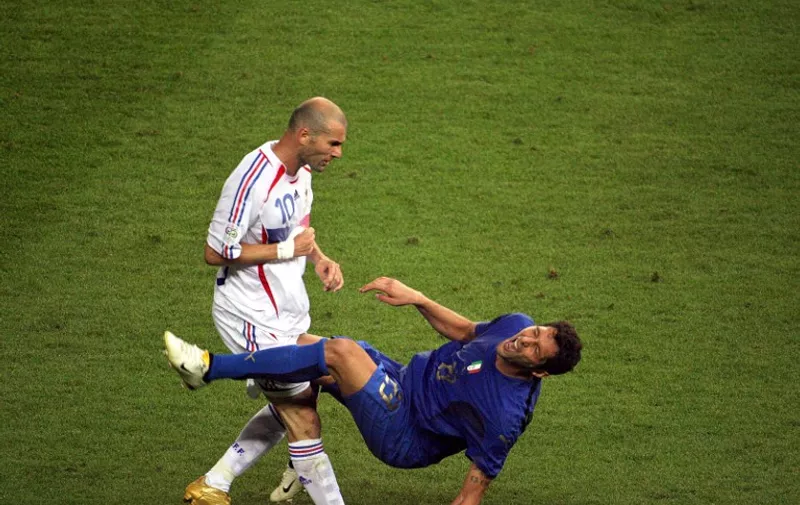 A photo taken 09 July 2006 of French midfielder Zinedine Zidane (L) gesturing after head butting Italian defender Marco Materazzi during the World Cup 2006 final football match between Italy and France at Berlins Olympic Stadium.  AFP PHOTO / JOHN MACDOUGALL
