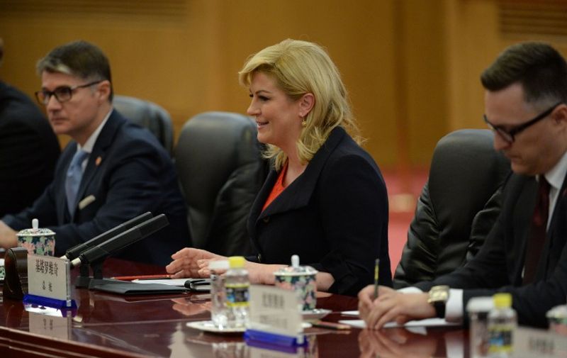 Croatian President Kolinda Grabar-Kitarovic (C), attends a meeting with Chinese President Xi Jinping (not seen) at the Great Hall of the People in Beijing on October 14, 2015. AFP PHOTO / POOL / Parker Song