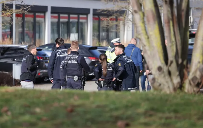 Police and other first responders work at the scene after a shooting at a school in Sankt Leon-Rot, southern Germany on January 25, 2024. (Photo by Daniel ROLAND / AFP)