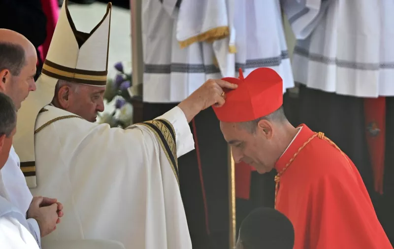 Argentinian prelate Victor Manuel Fernandez (R) is elevated cardinal by Pope Francis during a consistory to create 21 new cardinals at St. Peter's square in The Vatican on September 30, 2023. Pope Francis elevates 21 clergymen from all corners of the world to the rank of cardinal -- most of whom may one day cast ballots to elect his successor. (Photo by Filippo MONTEFORTE / AFP)