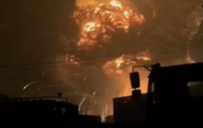 A screen grab from taken from state broadcaster China Central Television (CCTV) footage on August 12, 2015 shows a huge explosion in the northern Chinese port city of Tianjin. A series of massive explosions at a warehouse in the northern Chinese port city of Tianjin killed 13 people, state media reported on August 13, as witnesses described a fireball produced by the blasts ripping through the night sky. AFP PHOTO / CCTV

-- CHINA OUT -- 

-- RESTRICTED TO EDITORIAL USE - MANDATORY CREDIT "AFP PHOTO / CCTV" - NO MARKETING NO ADVERTISING CAMPAIGNS - DISTRIBUTED AS A SERVICE TO CLIENTS - NO ARCHIVES - TO BE USED WITHIN 14 DAYS (UNTIL 26 AUGUST 2015) --