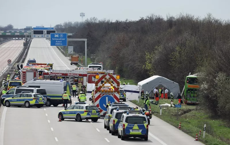 Emergency and police vehicles stand on the A9 highway at the scene of an accident where at least five people were killed on March 27, 2024 in Schkeuditz, near Leipzig, eastern Germany. (Photo by Jens Schlueter / AFP)