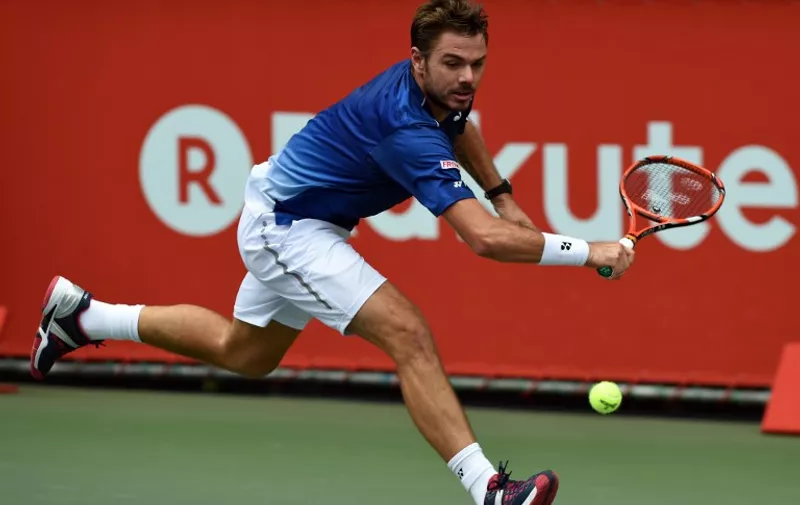 Top-seeded Stan Wawrinka of Switzerland hits a return against Gilles Muller of Luxembourg during their semi-final match at the Japan Open tennis tournament in Tokyo on October 10, 2015.   AFP PHOTO / TOSHIFUMI KITAMURA