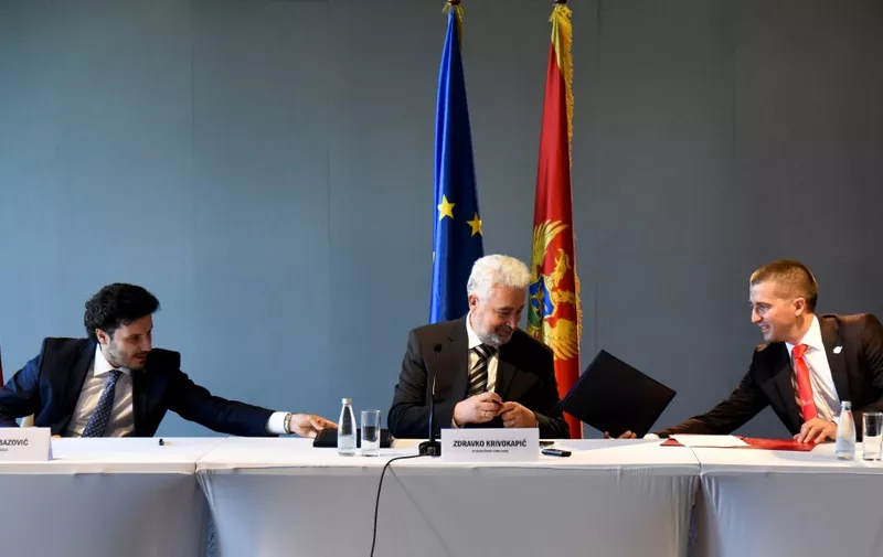 (L-R) Montenegro's opposition leaders, Dritan Abazovic of the liberal Black on White party, Zdravko Krivokapic of the main pro-Serb For the Future of Montenegro and Aleksa Becic of the centrist Democratic Montenegro sign an agreement in Podgorica on September 9, 2020, to form a coalition. - Montenegro's three opposition coalitions formally united on September 9 in hopes of ending the 30-year-run of a ruling party, with pledges to keep the EU candidate country on its pro-West path. The opposition camps span a broad idealogical spectrum but together hold a wafer-thin majority after last month's parliamentary elections. The largest of the coalitions is led by a pro-Russian and anti-NATO party, followed by a more centrist group and a smaller liberal civic bloc. In a written statement on September 9 they sought to assuage fears of breaking Montenegro's ties with the West, including its 2017 NATO membership. (Photo by Savo PRELEVIC / AFP)
