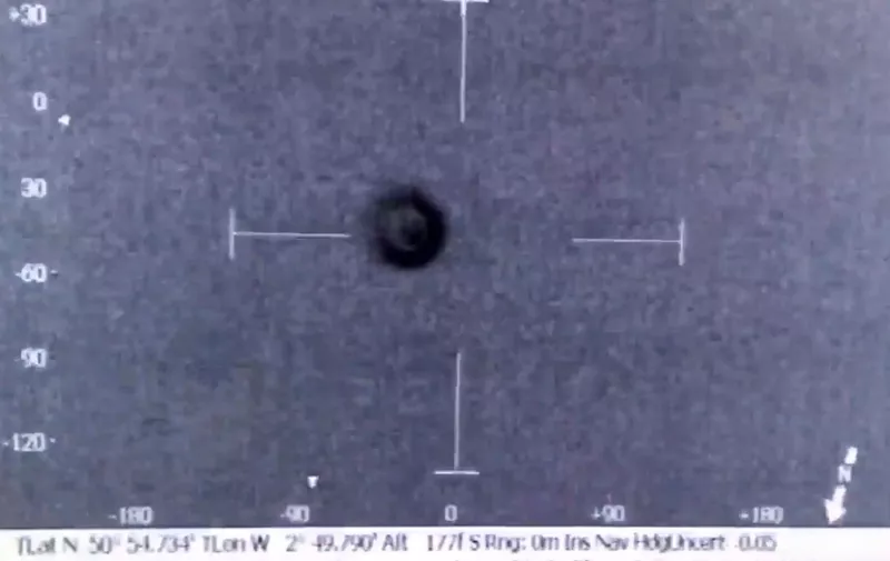 Video grab of the moment a UFO was captured on a police helicopter camera. See SWNS story SWUFO; The spherical object was filmed by the South Wales police helicopter while officers were flying 1,000ft over the Bristol Channel. Confused police said the mystery craft was flying against the wind and was undetected by air traffic control at around 9.30pm on Saturday (24). The object - which could not be seen with the normal eye - was captured by thermal cameras. None of the crew could come up with an explanation of what it was and the team tweeted it with an alien emoji and the question: "Any suggestion??" Some people have suggested it could be a balloon or a Chinese lantern, but police have ruled out both ideas because of the heat and movement. The force added: "It's difficult to judge the size but we filmed it for just over seven minutes.",Image: 301132578, License: Rights-managed, Restrictions: follow us on twitter - @swns
browse our website - swns.com
email pix@swns.com, Model Release: no