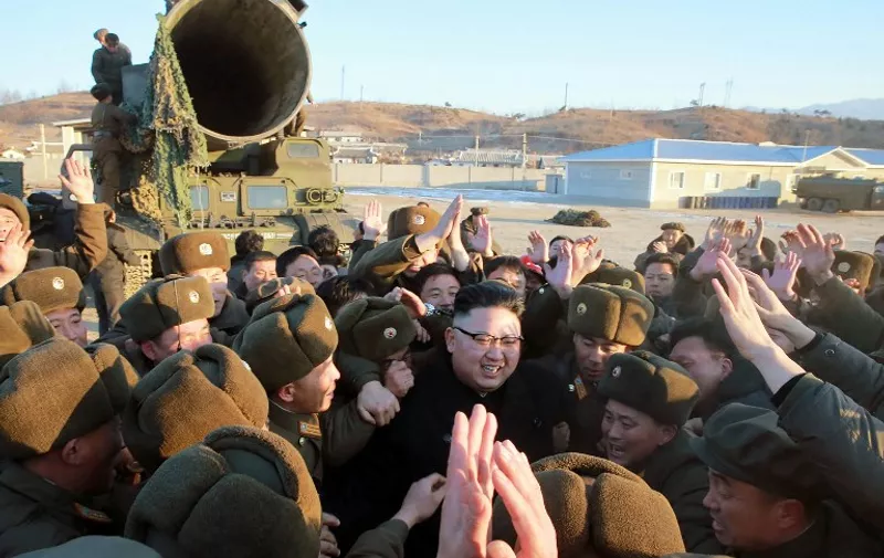 This photo taken on February 12, 2017 and released on February 13 by North Korea's official Korean Central News Agency (KCNA) shows North Korean leader Kim Jong-Un (C) surrounded by soldiers of the Korean People's Army as he inspects the test-launch of a surface-to-surface medium long-range ballistic missile Pukguksong-2 at an undisclosed location.
North Korea said on February 13 it had successfully tested a new ballistic missile, triggering a US-led call for an urgent UN Security Council meeting after a launch seen as a challenge to President Donald Trump. / AFP PHOTO / KCNA via KNS / STR / South Korea OUT / REPUBLIC OF KOREA OUT ---EDITORS NOTE--- RESTRICTED TO EDITORIAL USE - MANDATORY CREDIT "AFP PHOTO/KCNA VIA KNS" - NO MARKETING NO ADVERTISING CAMPAIGNS - DISTRIBUTED AS A SERVICE TO CLIENTS / THIS PICTURE WAS MADE AVAILABLE BY A THIRD PARTY. AFP CAN NOT INDEPENDENTLY VERIFY THE AUTHENTICITY, LOCATION, DATE AND CONTENT OF THIS IMAGE. THIS PHOTO IS DISTRIBUTED EXACTLY AS RECEIVED BY AFP.
 /