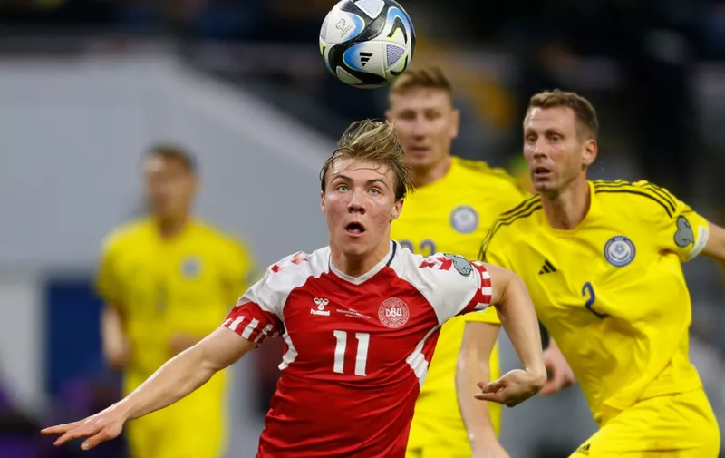 Denmark's Rasmus Hojlund, foreground, and Kazakhstan's Sergei Malyy, right, challenge for the ball during the Euro 2024 group H qualifying soccer match between Kazakhstan and Denmark at the Astana Arena stadium in Astana, Kazakhstan, Sunday, March 26, 2023. (AP Photo)