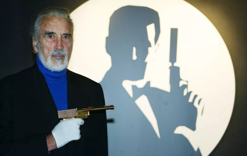 (FILES) In a file picture taken on October 15, 2002 British actor Christopher Lee holds the golden gun beside the Bond logo during the opening of the Bond, James Bond exhibit at The Science Museum in London. Christopher Lee, famous for playing Dracula, and villains in The Lord of the Rings and Star Wars, has died aged 93 on June 7, a local government official told AFP on June 11, 2015.   AFP PHOTO / ADRIAN DENNIS