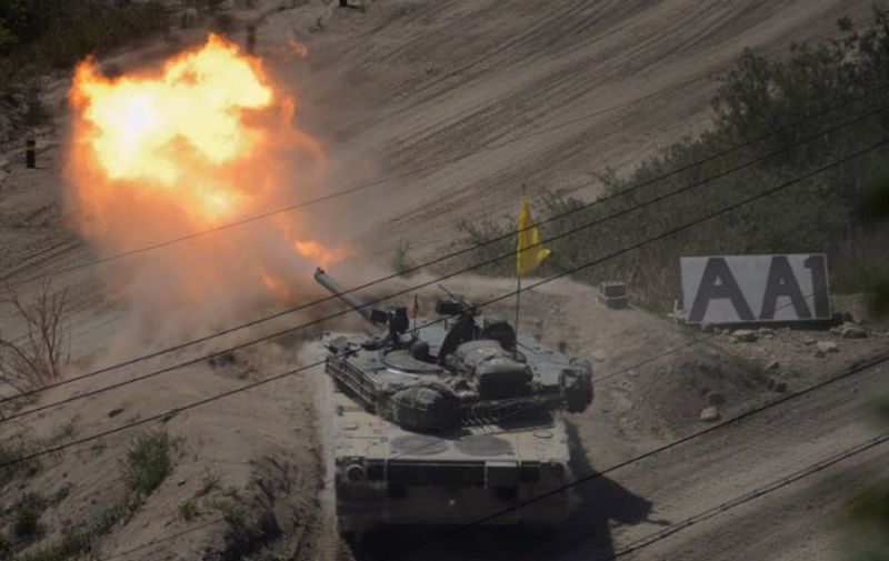 A South Korean tank of the 8th Mechanized Infantry Division takes part in a live-fire exercise at a training ground in Cheorwon, near the demilitarized zone (DMZ), on May 20, 2015. The 8th Mechanized Infantry Division operates at the 'front line' of the South-North border and consists of anti-tank and DMZ patrol companies, among others. AFP PHOTO / Ed Jones / AFP / ED JONES
