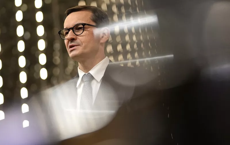 Poland's Prime Minister Mateusz Morawiecki speaks with the media as he departs at the end of the first day of the EU summit at the European Council building in Brussels on May 24, 2021. - European Union leaders take part in a two day in-person meeting to discuss the coronavirus pandemic, climate and Russia. (Photo by Francisco SECO / POOL / AFP)