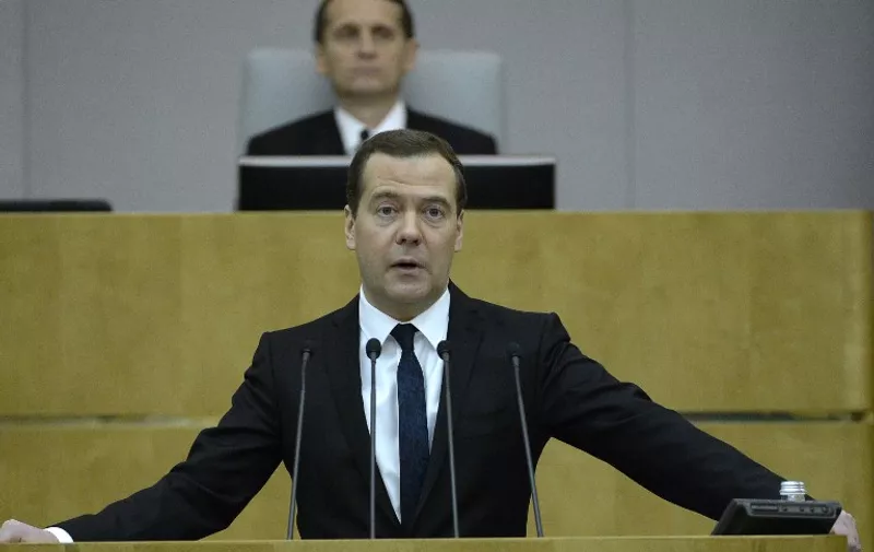 Russian Prime Minister Dmitry Medvedev speaks in the lower house of Russia's parliament, the State Duma, in Moscow on April 21, 2015. Dmitry Medvedev on April 21 estimated the economy shrank by two percent in the first three months of the year, due to sanctions pressure and low oil prices. AFP PHOTO / YURI KADOBNOV / AFP / YURI KADOBNOV