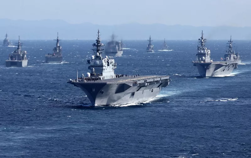 (FILES) This file photo taken on November 6, 2022 shows military vessels, including Japan's Maritime Self-Defense Force's largest escort ship "Izumo" (C), sailing in Sagami Bay during the "International Fleet Review", held by Japan's Maritime Self-Defense Force with some 12 other countries, off Kanagawa Prefecture. - Japan announced on December 16, 2022 its biggest defence overhaul in decades, hiking spending, reshaping its military command and acquiring new missiles to tackle the threat from China. (Photo by JIJI Press / AFP) / Japan OUT