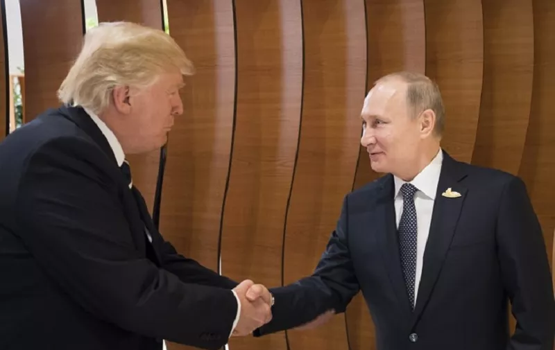 This handout taken on July 7, 2017 released by the German government shows US President Donald Trump (L) shaking hands with his Russian counterpart Vladimir Putin during a G20 summit in Hamburg, northern Germany, on July 7, 2017.
Leaders of the world's top economies gather from July 7 to 8, 2017 in Germany for likely the stormiest G20 summit in years, with disagreements ranging from wars to climate change and global trade. / AFP PHOTO / Bundesregierung / Steffen KUGLER / RESTRICTED TO EDITORIAL USE - MANDATORY CREDIT "AFP PHOTO / BUNDESREGIERUNG" - NO MARKETING NO ADVERTISING CAMPAIGNS - DISTRIBUTED AS A SERVICE TO CLIENTS == NO ARCHIVE