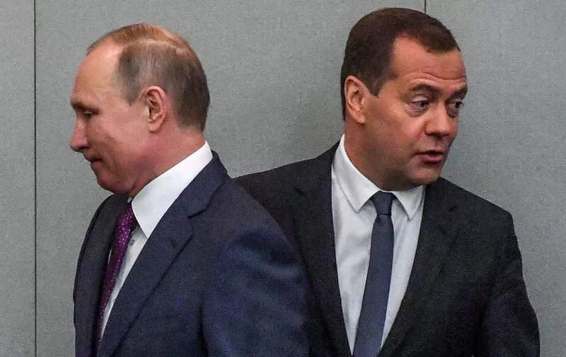 Russia's President Vladimir Putin and acting Prime Minister Dmitry Medvedev attend a session of the State Duma in Moscow on May 8, 2018. - The Russian parliament on May 8, 2018 voted to back a new mandate for prime minister Dmitry Medvedev, a longtime ally of President Vladimir Putin who also served a Kremlin term from 2008 to 2012. (Photo by Yuri KADOBNOV / AFP)