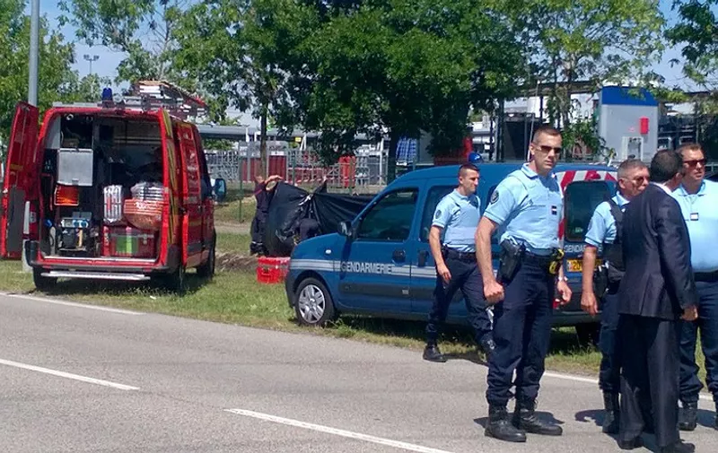 French police cordon off the area where a decapitated body is believed to have been found near the Air Products company, in Saint-Quentin-Fallavier, near Lyon, central eastern France, on June 26, 2015. An attacker carrying an Islamist flag killed one person and injured several others at a gas factory in eastern France, according to a legal source. The suspected attacker entered the factory and set off several small explosive devices, the source said. AFP PHOTO/PHILOMENE BOUILLON