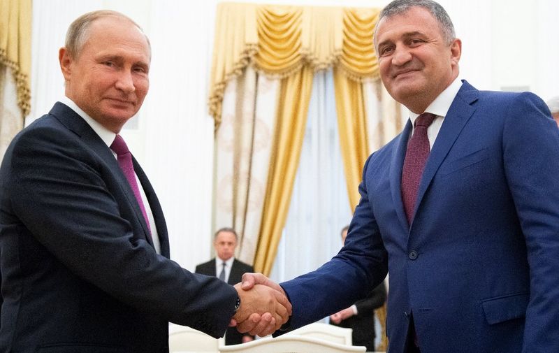 Russian President Vladimir Putin (L) and Anatoly Bibilov, the leader of Georgia's breakaway region of South Ossetia  shake hands prior to their meeting in the Kremlin in Moscow on August 24, 2018. (Photo by Alexander Zemlianichenko / POOL / AFP) / The erroneous mention[s] appearing in the metadata of this photo by Alexander Zemlianichenko has been modified in AFP systems in the following manner: Anatoly Bibilov instead of Leonid Tibilov. Please immediately remove the erroneous mention[s] from all your online services and delete it (them) from your servers. If you have been authorized by AFP to distribute it (them) to third parties, please ensure that the same actions are carried out by them. Failure to promptly comply with these instructions will entail liability on your part for any continued or post notification usage. Therefore we thank you very much for all your attention and prompt action. We are sorry for the inconvenience this notification may cause and remain at your disposal for any further information you may require.