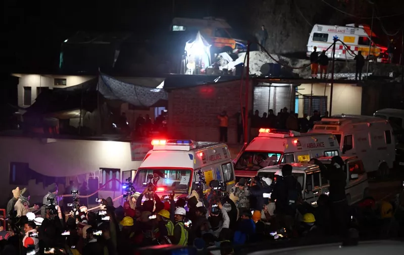 Ambulances carrying rescued workers leave the tunnel site after emergency and rescue teams safely brought out all trapped workers from the collapsed Silkyara tunnel in the Uttarkashi district of India's Uttarakhand state on November 28, 2023. Indian workers were greeted with wild cheers and flower garlands on November 28 as rescuers safely brought out all 41 from the collapsed Himalayan road tunnel where they were trapped after a marathon 17-day engineering operation. (Photo by Sajjad HUSSAIN / AFP)