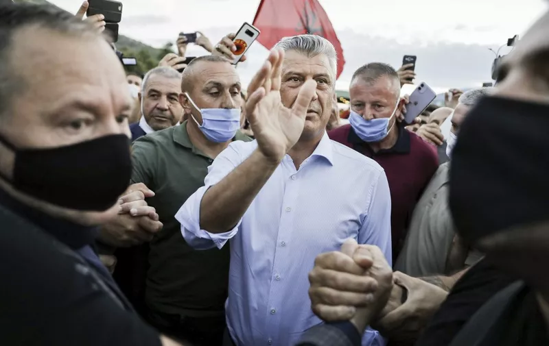Kosovo President Hashim Thaci (C) greets his supporters and Kosovo Liberation Army (KLA) war veterans who gathered to welcome him upon his arrival at the border crossing between Albania and Kosovo in the village of Vermice, on July 17, 2020. - Thaci came back in Kosovo after four days of questioning by the Hague prosecutors following the indictments, of crimes against humanity and war crimes by the Prosecutor of the Specialist Chambers for Kosovo, an international tribunal based in The Hague.
 Thaci, a former political leader of an ethnic Albanian guerrilla group, was charged in late June by the Kosovo Specialist Chambers of war crimes and crimes against humanity linked to the 1998-99 conflict. (Photo by STRINGER / AFP)