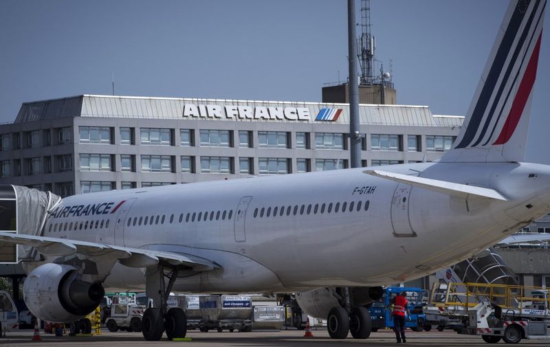 (FILES) This file photo taken on August 07, 2018 shows an Air France aircraft on the tarmac near Air France-KLM headquarters at Roissy-Charles de Gaulle Airport, north of Paris. - A number of airlines say they are halting or reducing flights to China as the country struggles to contain the spread of the deadly coronavirus. China has advised its citizens to postpone trips abroad and cancelled overseas group tours, while several countries have urged their citizens to avoid travel to China if possible. The coronavirus epidemic has killed 132 people, infected nearly 6,000, and spread to some 15 countries. Air France suspended its three weekly flights to Wuhan on January 24, 2020. On January 29, 2020 it announced that flights to Beijing and Shanghai would be suspended from Friday. (Photo by JOEL SAGET / AFP)