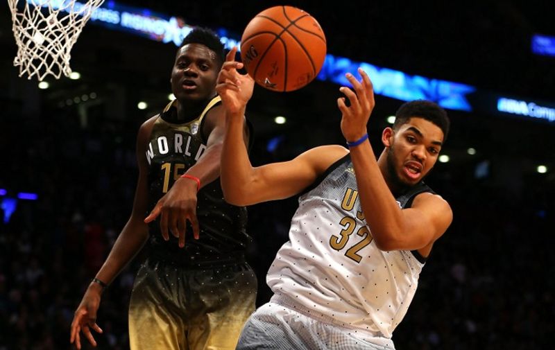 TORONTO, ON - FEBRUARY 12: Karl-Anthony Towns #32 of the Minnesota Timberwolves and the United States team competes for the ball with Clint Capela #15 of the Houston Rockets and World team in the second half during the BBVA Compass Rising Stars Challenge 2016 at Air Canada Centre on February 12, 2016 in Toronto, Canada. NOTE TO USER: User expressly acknowledges and agrees that, by downloading and/or using this Photograph, user is consenting to the terms and conditions of the Getty Images License Agreement.   Elsa/Getty Images/AFP