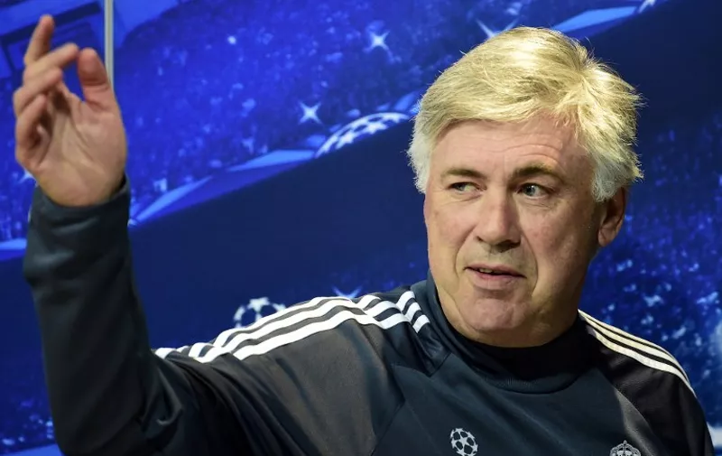 (FILES) A file picture taken on May 12, 2015 shows Real Madrid's Italian coach Carlo Ancelotti waving as he leaves a press conference at Valdebebas training ground in Madrid on the eve of the UEFA Champions League semi-final second leg football match Real Madrid CF vs Juventus. Real Madrid's coach Carlo Ancelotti swims in a paradox, supported by the public and players, including star Cristiano Ronaldo, he could be fired by the president Florentino Perez after a disappointing season.    AFP PHOTO / GERARD JULIEN