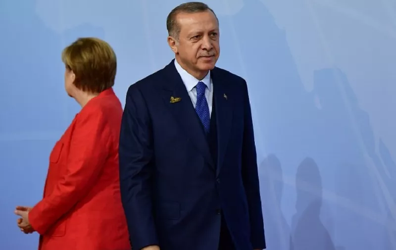 German Chancellor Angela Merkel welcomes Turkey's President Recep Tayyip Erdogan as he arrives to attend the G20 summit in Hamburg, northern Germany, on July 7, 2017.
Leaders of the world's top economies gather from July 7 to 8, 2017 in Germany for likely the stormiest G20 summit in years, with disagreements ranging from wars to climate change and global trade. / AFP PHOTO / Tobias SCHWARZ