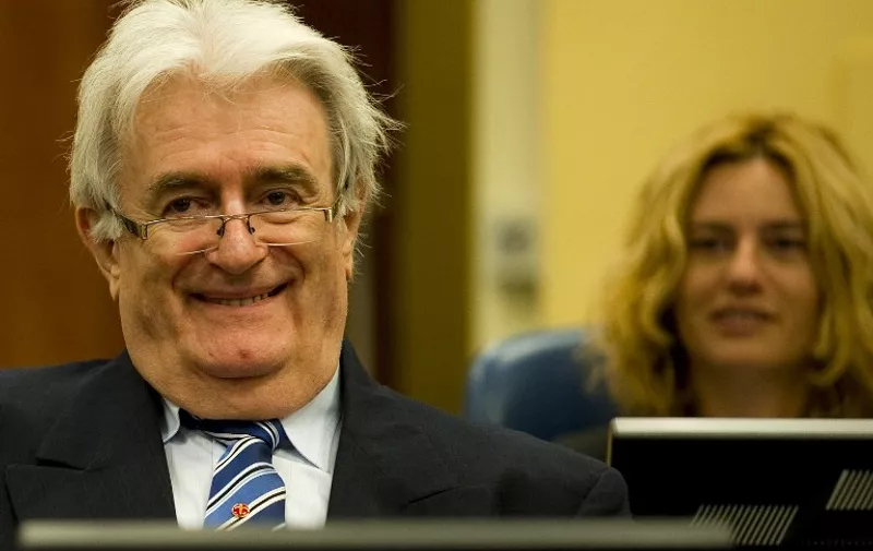 Former Bosnian Serb leader Radovan Karadzic sits in the courtroom on the first day of his defense against war crime charges at the International Criminal Tribunal for the Former Yugoslavia in The Hague, Netherlands on October 16, 2012. The Yugoslavia  war crimes tribunal begins trying its last suspect on Tuesday. A strident Radovan Karadzic told the UN Yugoslav war crimes court Tuesday that nobody thought there would be genocide in Bosnia and that he should be rewarded for doing all to avoid war. AFP PHOTO / POOL -  Robin van Lonkhuijsen