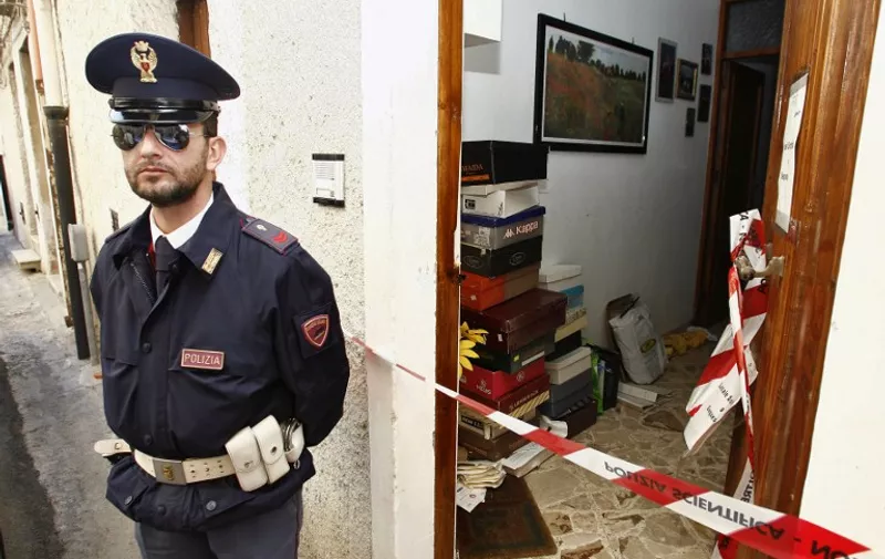 An Italian policeman stands guard on November 16, 2009, in front of the house where was arrested late last night Domenico Raccuglia, the number two leader of Sicily's Cosa Nostra Mafia after 15 years on the run, in Trapani, suburb of Calatafimi. Raccuglia, 45, nicknamed "the veterinarian" for his love of animals and considered one of Italy's 30 most dangerous fugitives, has been sentenced separately to three life jail terms including for his role in the kidnapping and murder of a teenage son of a mafia turncoat. AFP PHOTO/ MARCELLO PATERNOSTRO