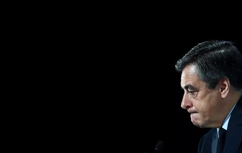 (FILES) This file photo taken on March 4, 2017 in Aubervilliers, outside Paris shows French presidential election candidate for the right-wing Les Republicains (LR) party Francois Fillon looking on as he presents his programm.
France's rightwing presidential candidate Francois Fillon has been charged with several offences over a fake jobs scandal, including for misuse of public funds, his lawyer told AFP on March 14, 2017. "He was charged this morning. The hearing was brought forward so that it could take place in a calm manner," his lawyer Antonin Levy told AFP. / AFP PHOTO / Martin BUREAU
