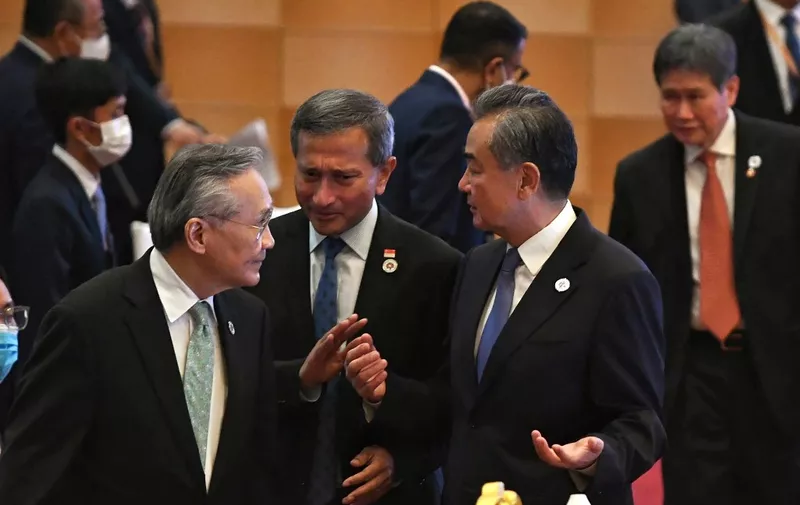 China's Foreign Minister Wang Yi (2nd R) talks to Singapore's Foreign Minister Vivian Balakrishnan (C) and Thailand's Foreign Minister Don Pramudwinai (L) at the ASEAN-China Ministerial Meeting during the 55th ASEAN Foreign Ministers' Meeting in Phnom Penh on August 4, 2022. (Photo by Tang Chhin Sothy / AFP)