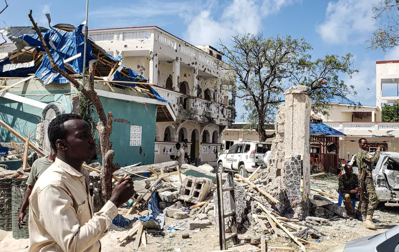 A man passes in front of the rubbles of the popular Medina hotel of Kismayo on July 13, 2019, a day after at least 26 people, including several foreigners, were killed and 56 injured in a suicide bomb and gun attack claimed by Al-Shabaab militants. A suicide bomber rammed a vehicle loaded with explosives into the Medina hotel in the port town of Kismayo before several heavily armed gunmen forced their way inside, shooting as they went, authorities said., Image: 458120410, License: Rights-managed, Restrictions: , Model Release: no, Credit line: Profimedia, AFP