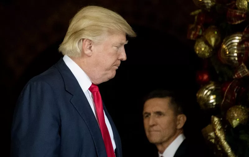 (FILES): This file photo taken on December 21, 2016 shows then US President-elect Donald Trump (L) standing with Trump National Security Adviser Lt. General Michael Flynn (R) at Mar-a-Lago in Palm Beach, Florida.
The White House announced February 13, 2017 that Michael Flynn has resigned as President Donald Trump's national security advisor, amid escalating controversy over his contacts with Moscow. In his formal resignation letter, Flynn acknowledged that in the period leading up to Trump's inauguration: "I inadvertently briefed the vice president-elect and others with incomplete information regarding my phone calls with the Russian ambassador."
Trump has named retired lieutenant general Joseph Kellogg, who was serving as a director on the Joint Chiefs of Staff, as acting national security advisor, the White House said. 
 / AFP PHOTO / JIM WATSON