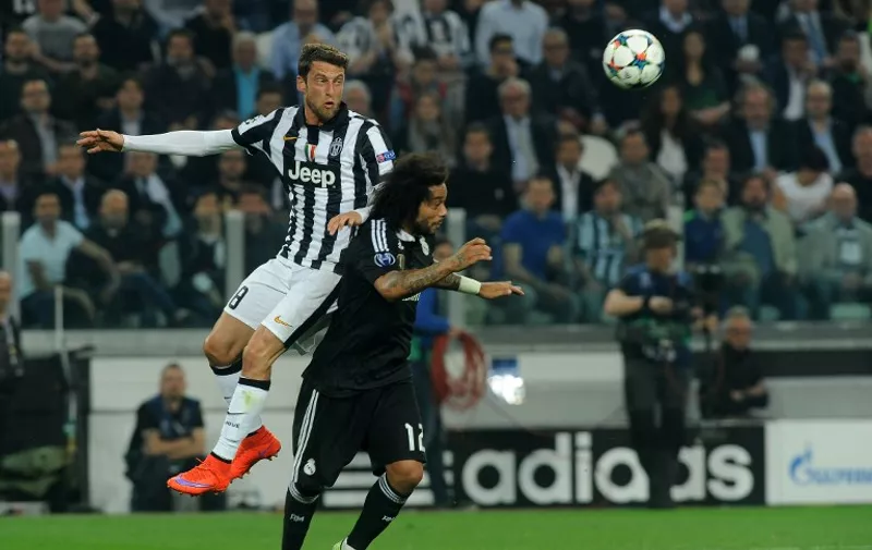 ClaudioMarchisio of Juventus FC and Marcelo of Real Madrid CF jump for the ball during the UEFA Champions League semi-final first leg football match between Juventus and Real Madrid on May 5, 2015 at the Juventus stadium in Turin, Italy. Photo  / DPPI